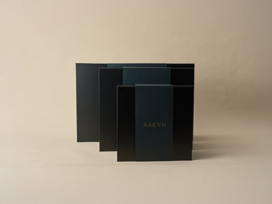 Stacked black Asend presentation boxes in a range of sizes