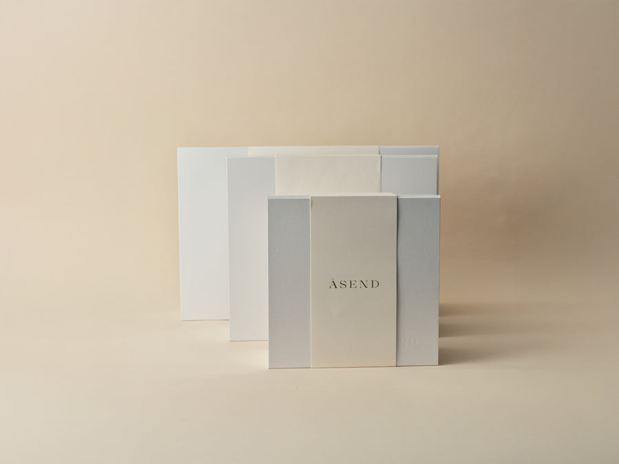 Stacked white Asend presentation boxes in a range of sizes